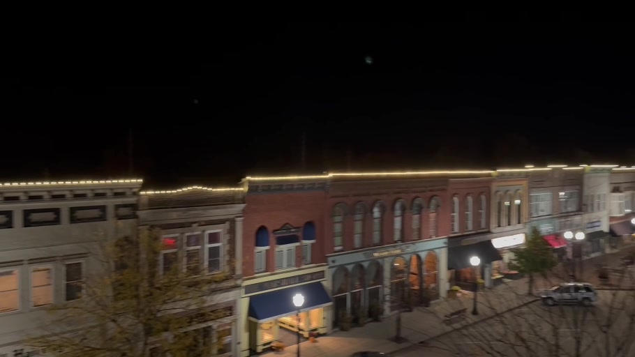 Downtown Dowagiac storefronts outlined with coordinated holiday lighting